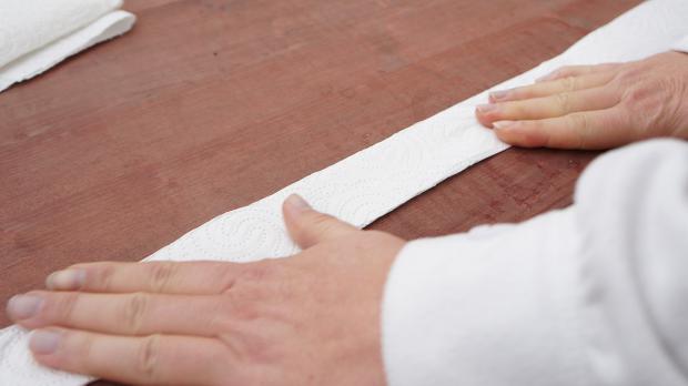 Küchenpapier der Länge nach falten